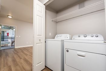 A white washer and dryer in a laundry room.
